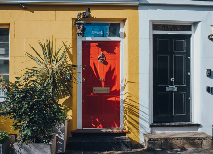 Terrace house with red door and yellow bricks 