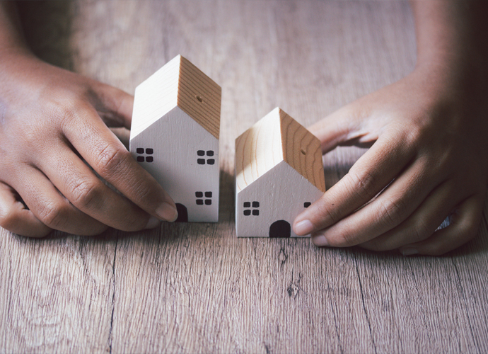 two wooden houses on a table 