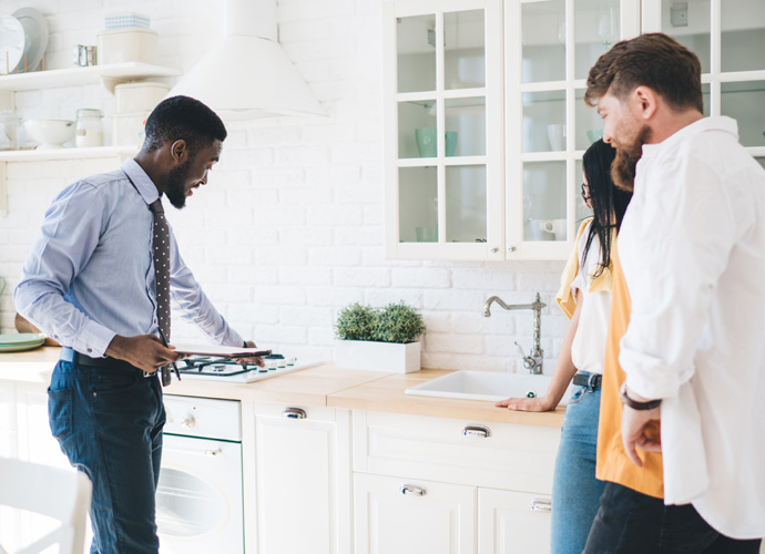 Man showing couple round a kitchen 