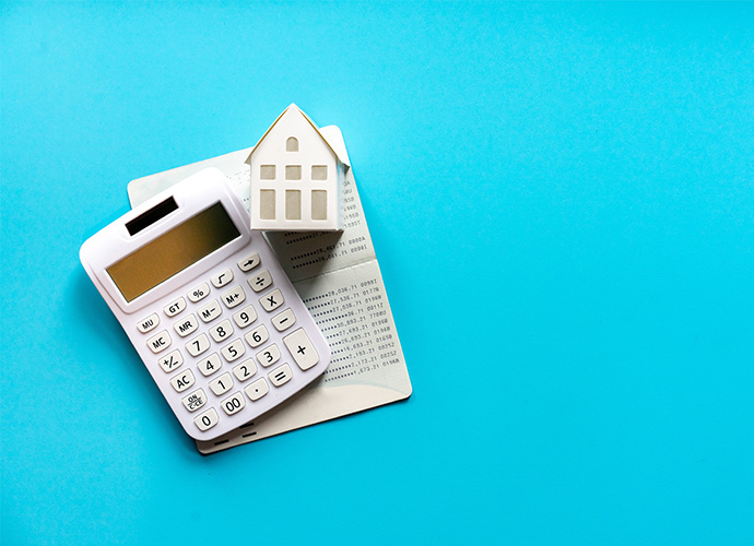 Calculator and house on a blue background 