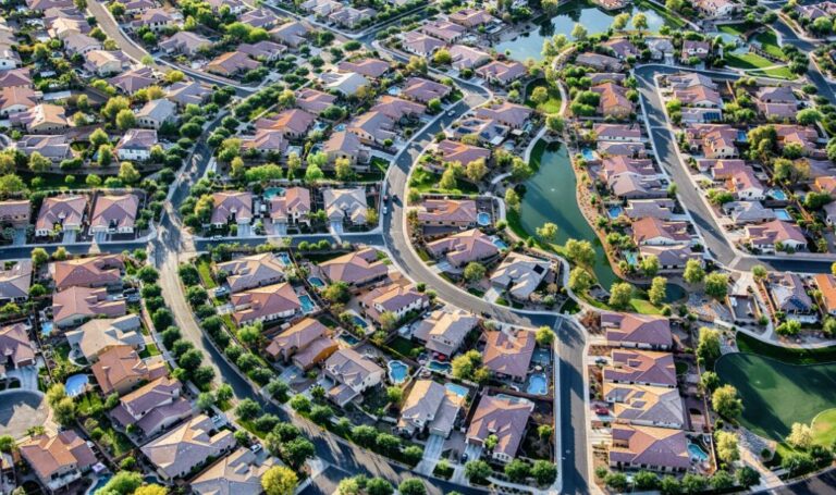 Aerial view of a residential neighbourhood with rental homes, showing the impact of a base rate cut in 2026.