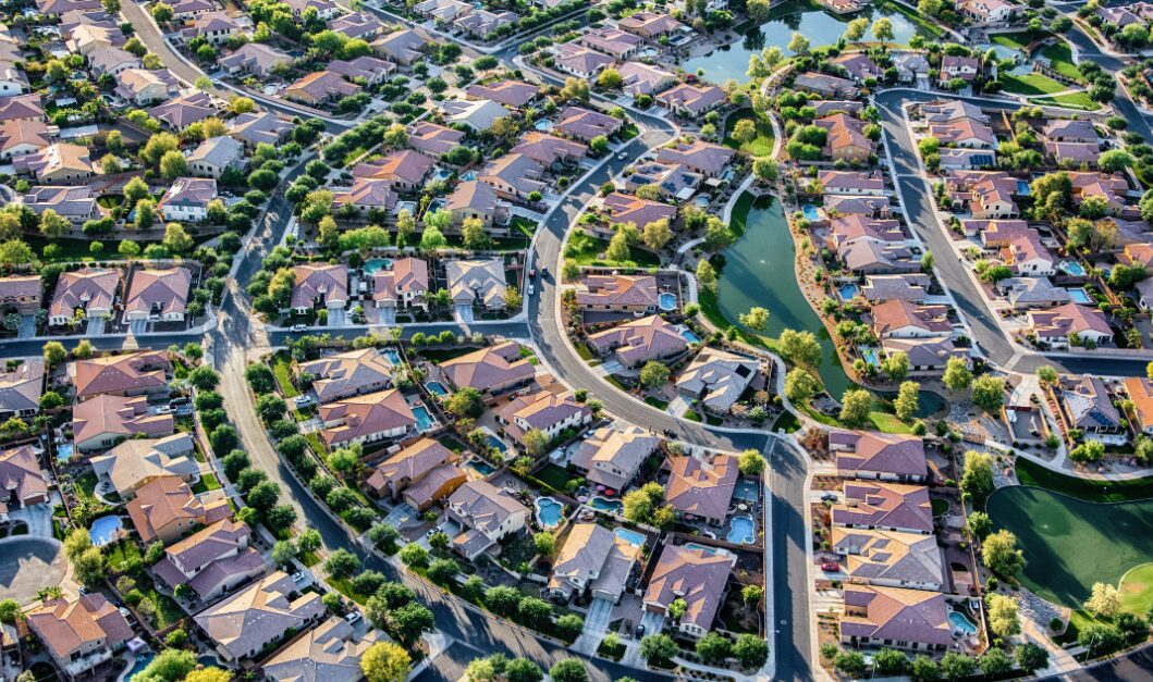 Aerial view of a residential neighbourhood with rental homes, showing the impact of a base rate cut in 2026.