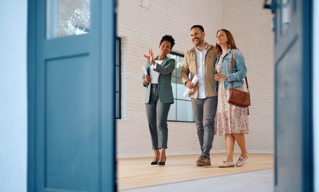 Estate agent showing a Hitchin property to buyers following Universal Studios Bedford green light