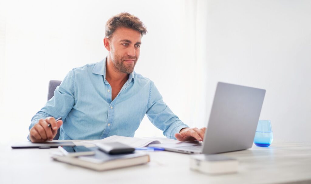 Landlord reviewing rental figures on a laptop while preparing a compliant Section 13 rent increase for a student or HMO property