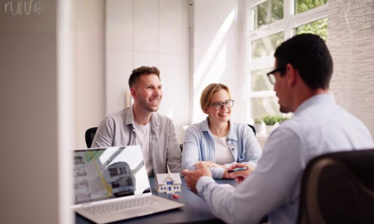 Homeowners meeting with an estate agent to discuss downsizing and property value in Stoneygate Leicester.
