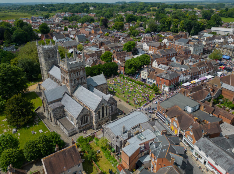 Aerial view of Wimborne showing historic buildings, a church, and a busy town square