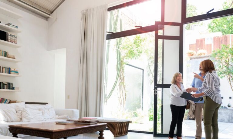 Estate agent welcoming buyers into a modern Leicester property during a home viewing