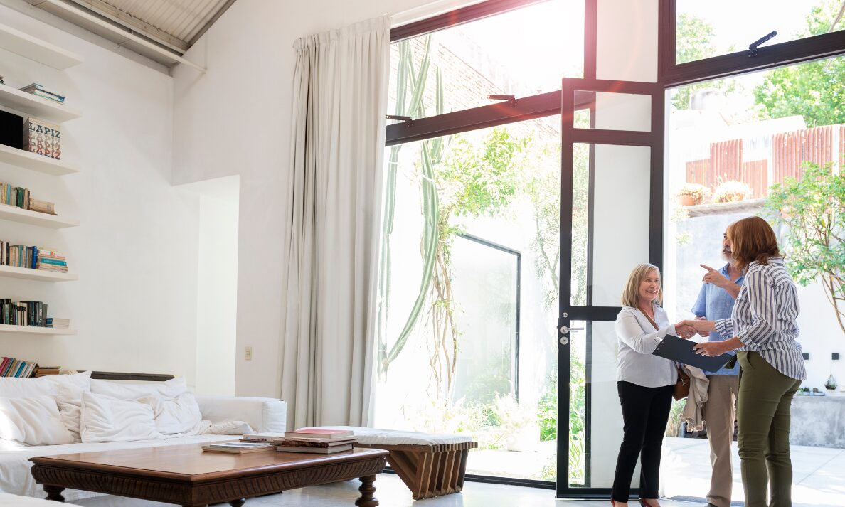 Estate agent welcoming buyers into a modern Leicester property during a home viewing