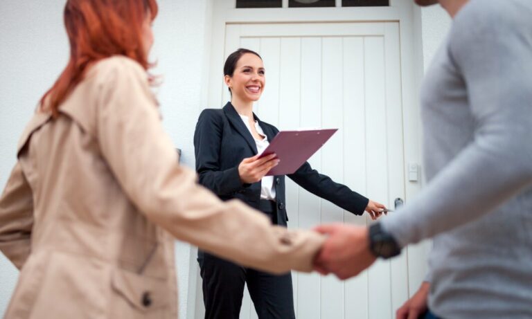 Estate agent welcoming prospective buyers to a property in Corfe Mullen BH21