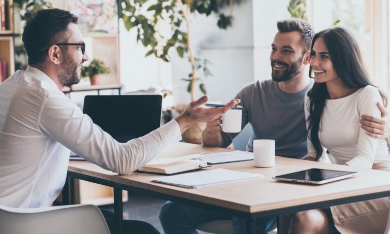 Letting agent discussing rental legislation and tenancy documents with landlords during a property consultation in Wimborne.
