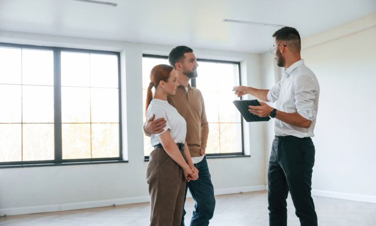 Couple viewing a property with an estate agent in Leicester