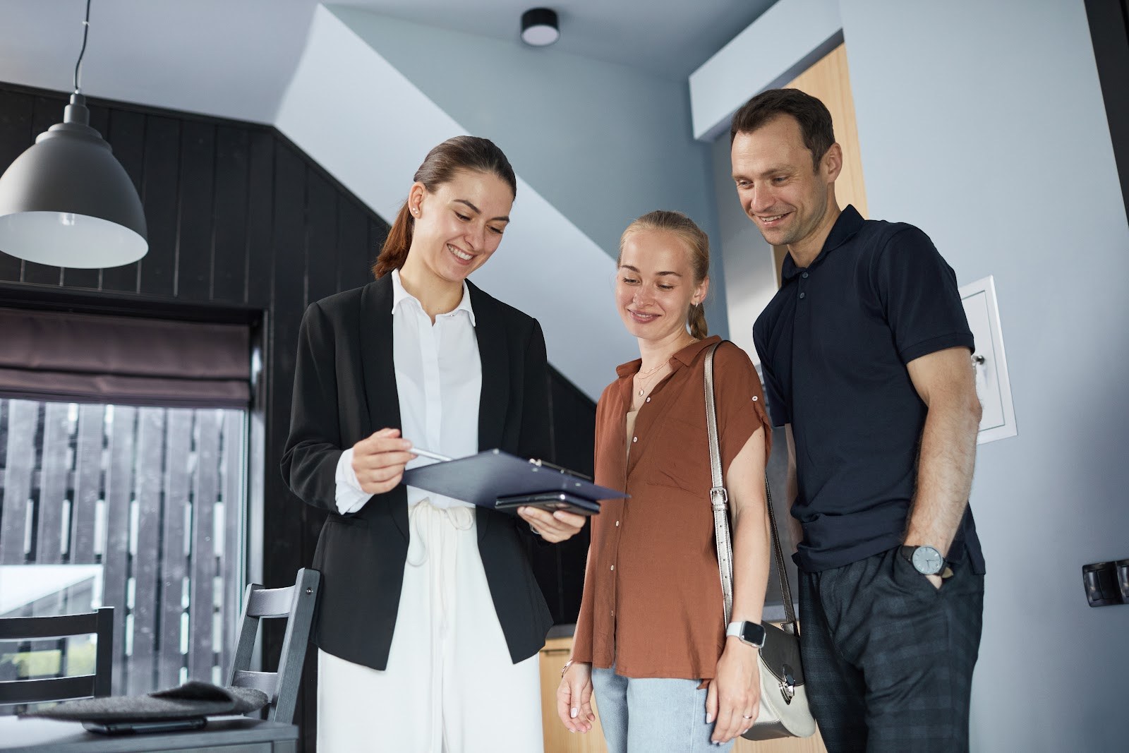 Young couple talking with an estate agent about buying a home in Stapehill, Wimborne BH21